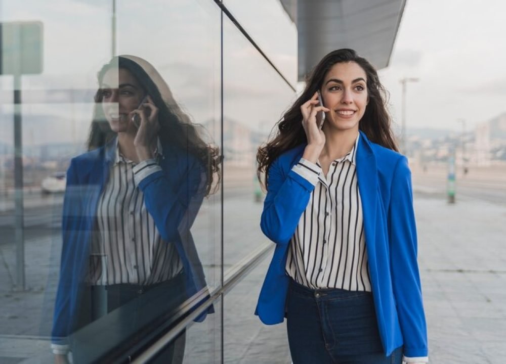 elegant-young-businesswoman-talking-phone_23-2147605101