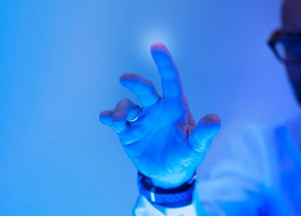 man-touching-futuristic-blue-screen_53876-143029